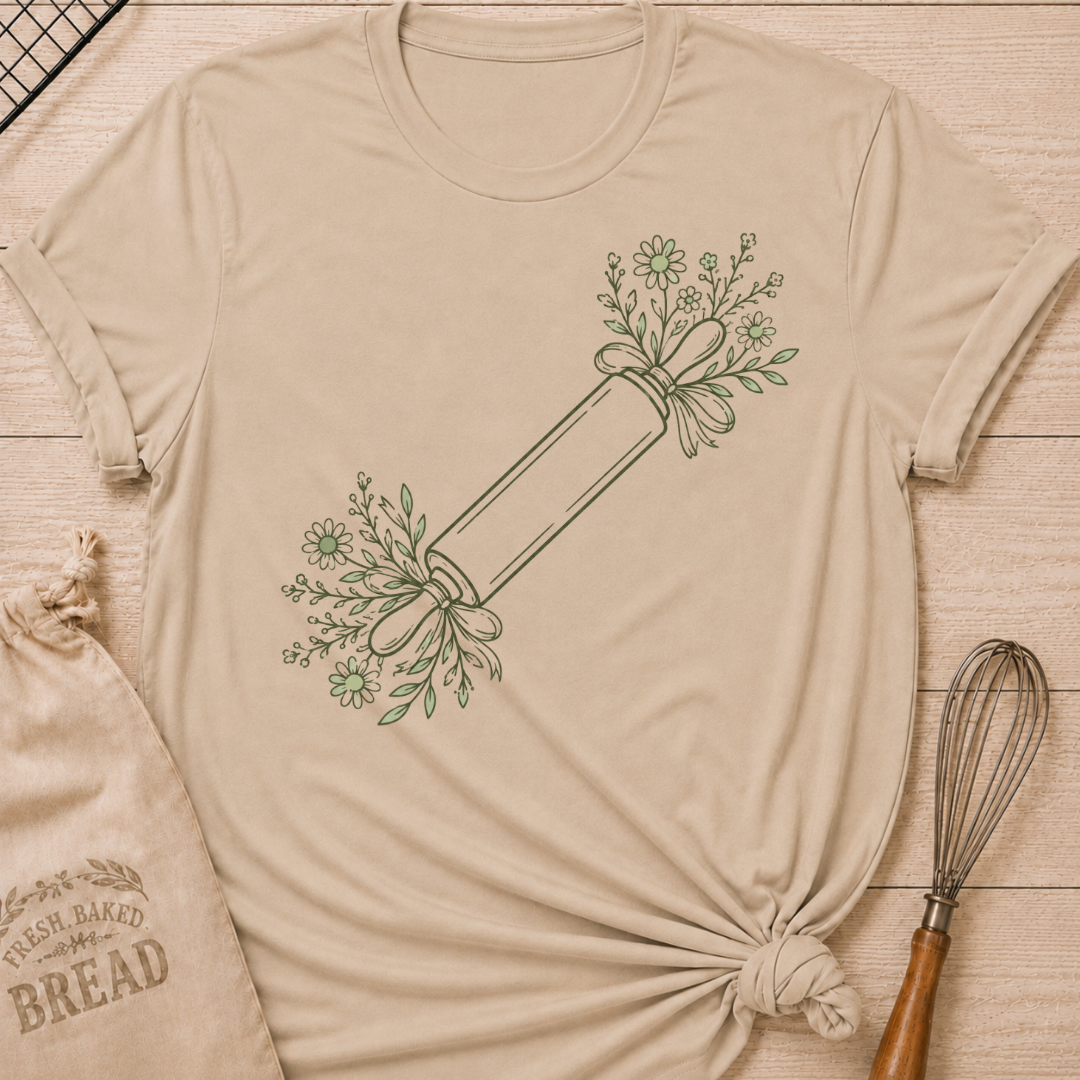 Heather stone women's relaxed fit t-shirt with a rolling pin dressed in soft floral sprigs and bows.