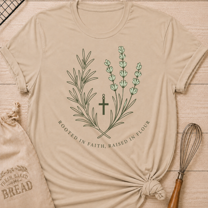 Heather stone women's relaxed fit t-shirt with rosemary, lavender and a simple cross and the words Rooted in Faith, Raised in Flour.