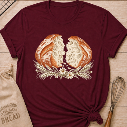 Maroon women's relaxed fit tee with a torn artisan loaf showing its airy crumb, framed by wheat and delicate wildflowers