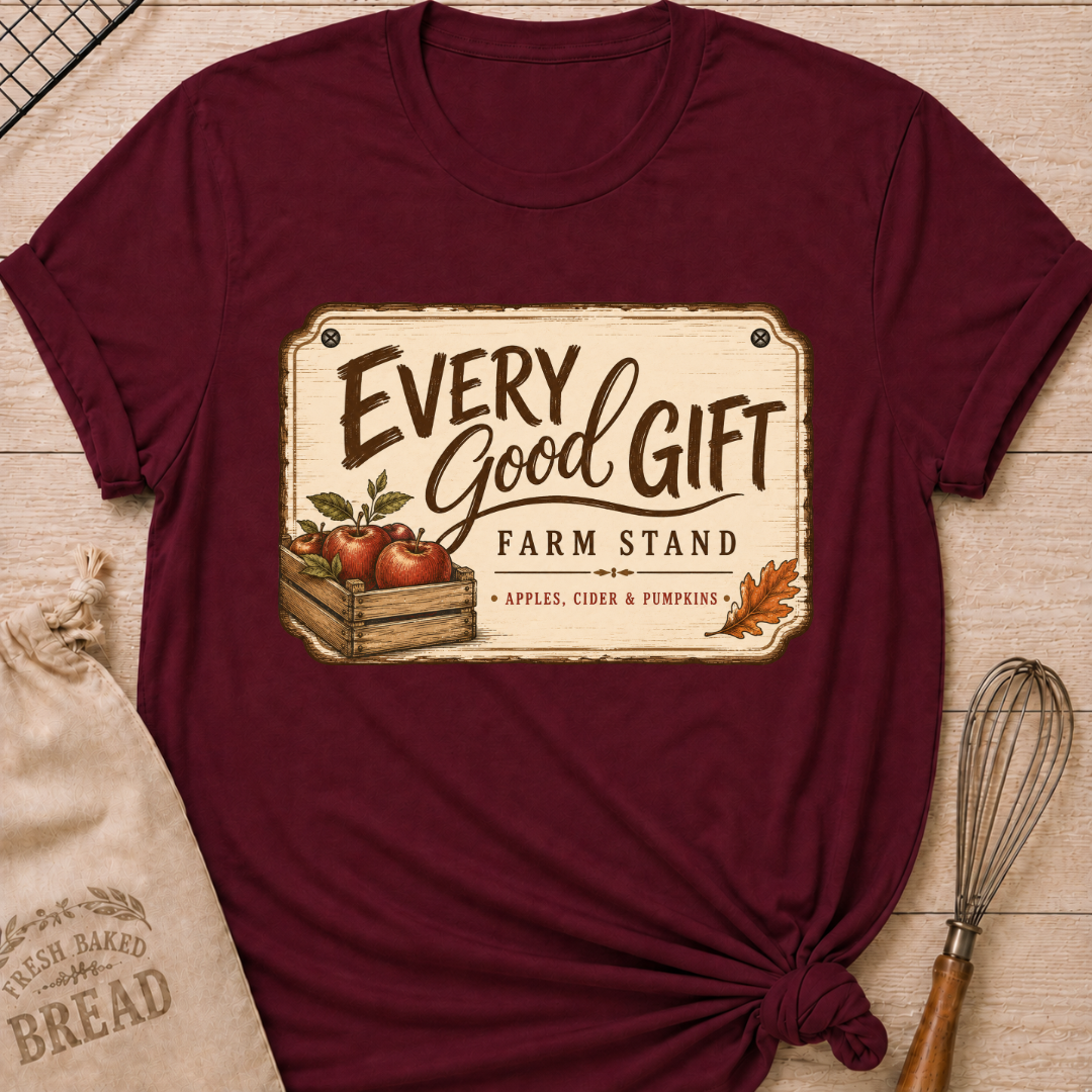 Maroon women's relaxed fit tee with a vintage farm stand design, a wooden crate of apples, cider and pumpkins
