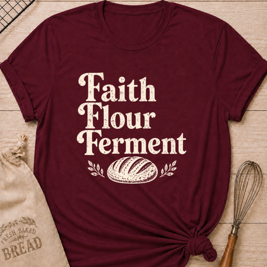 Maroon women's relaxed fit t-shirt with the words Faith, Flour, Ferment in bold vintage lettering with a classic artisan loaf and subtle leafy accents.