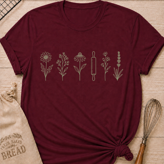Maroon women's relaxed fit t-shirt with a classic rolling pin and a row of delicate wildflowers in soft sage and cream.