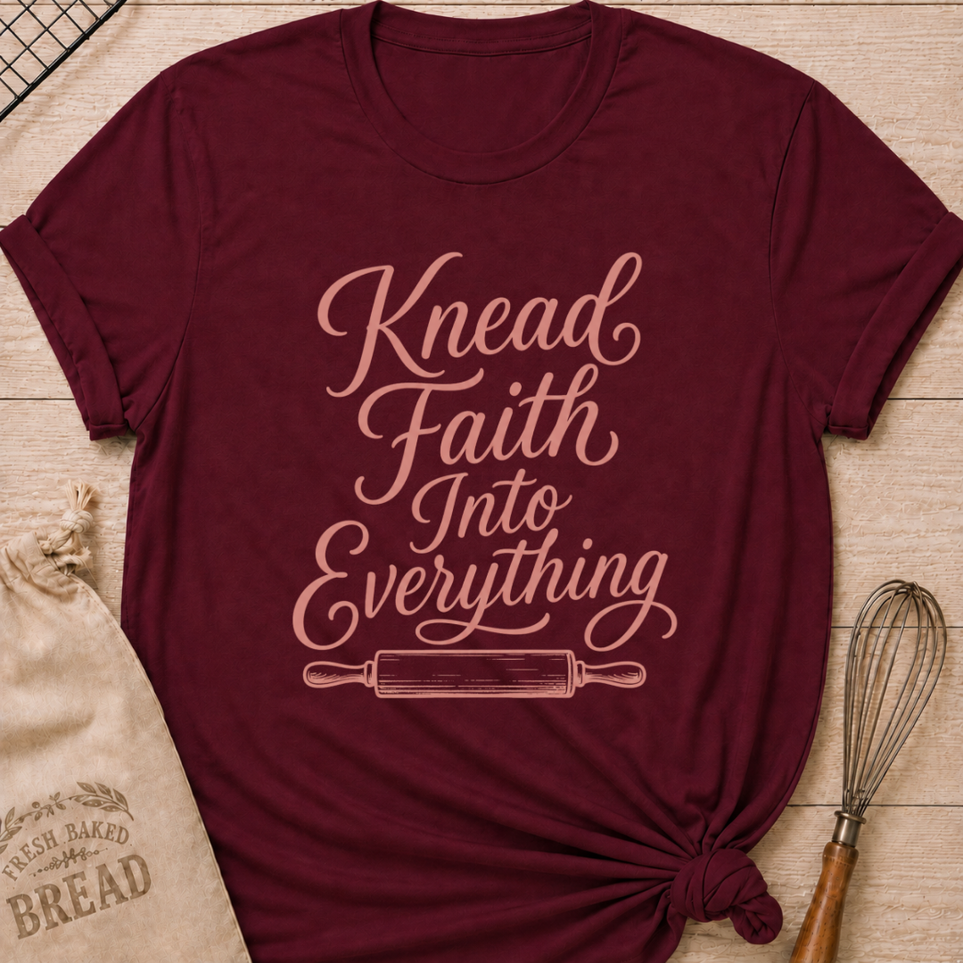 Maroon women's relaxed fit t-shirt with Knead Faith Into Everything in graceful script and a classic rolling pin.