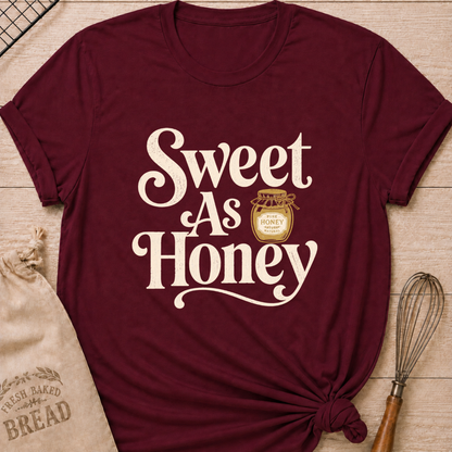 Maroon women's relaxed fit t-shirt with the words Sweet as Honey in playful vintage lettering and a jar of golden honey.