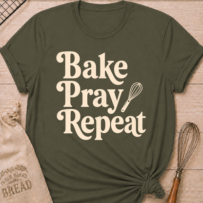 Military green women's relaxed fit t-shirt with the words Bake, Pray, Repeat in playful vintage lettering and a classic kitchen whisk.