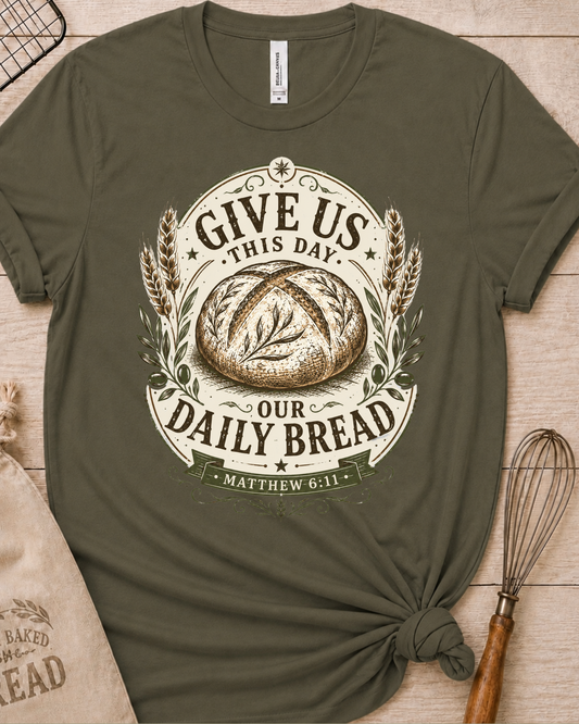 Military green women's relaxed fit t-shirt with the Daily Bread emblem printed in cream, a clean badge-style bread illustration inspired by Matthew 6:11.