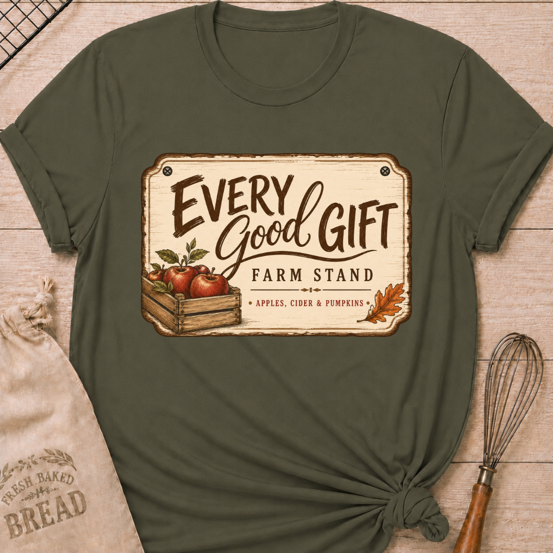 Military Green women's relaxed fit tee with a vintage farm stand design, a wooden crate of apples, cider and pumpkins