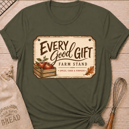 Military Green women's relaxed fit tee with a vintage farm stand design, a wooden crate of apples, cider and pumpkins