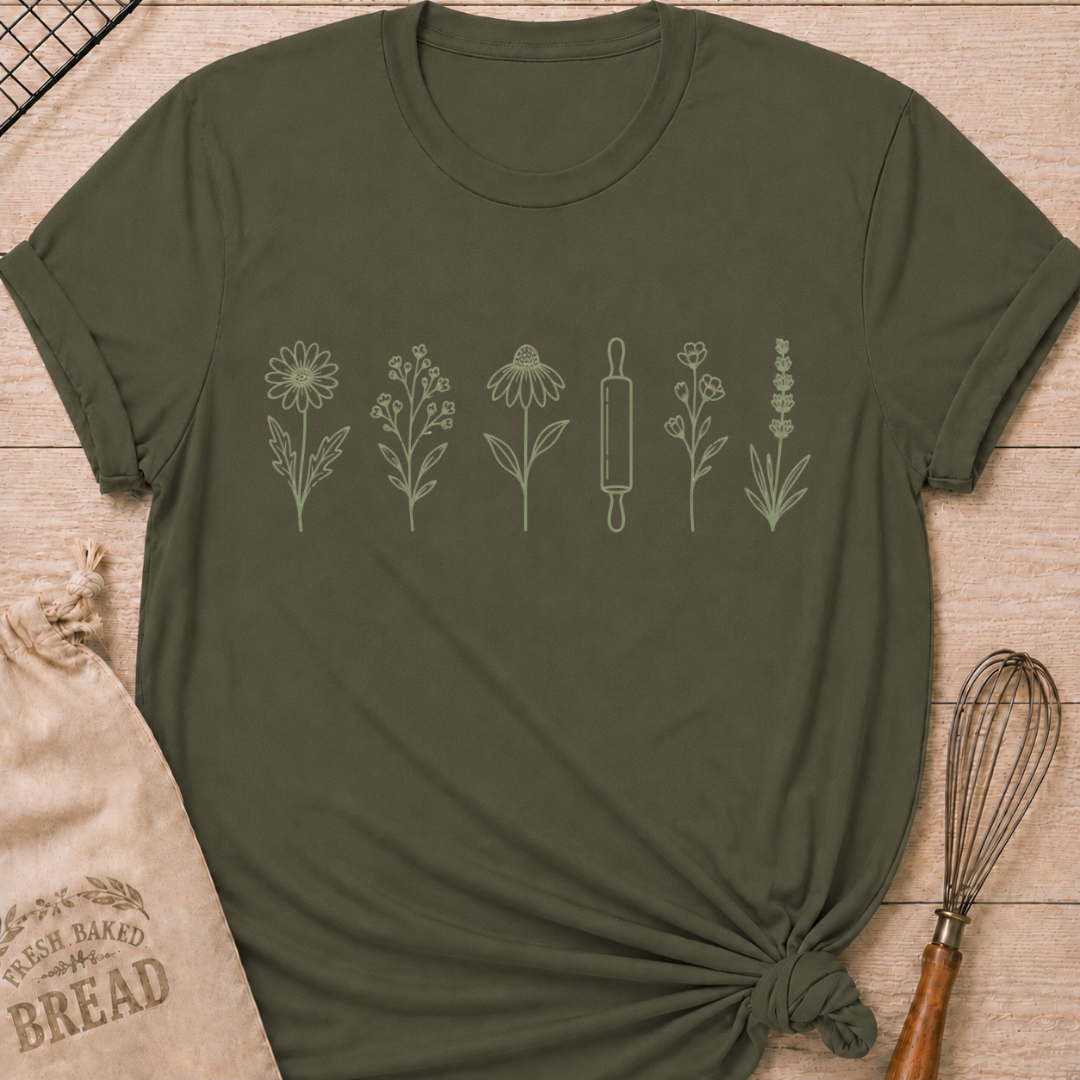 Military green women's relaxed fit t-shirt with a classic rolling pin and a row of delicate wildflowers in soft sage and cream.