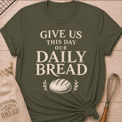 Military green women's relaxed fit t-shirt with the words Give Us This Day Our Daily Bread in bold vintage lettering above a rustic loaf and leafy accents.