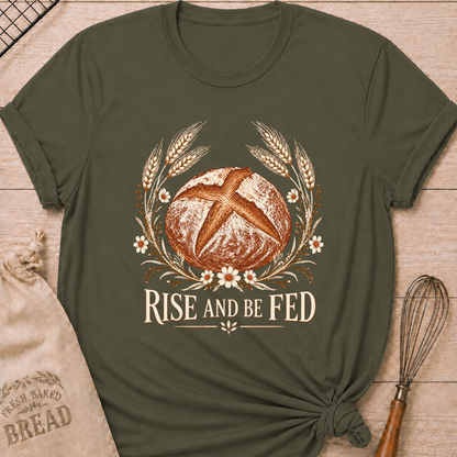 Military Green women's relaxed fit tee with a detailed artisan loaf framed by wheat and delicate wildflowers in a soft vintage style, above Rise and Be Fed lettering