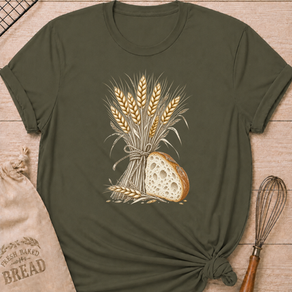 Military Green women's relaxed fit tee with a hand-tied bundle of golden wheat beside a richly textured slice of artisan bread