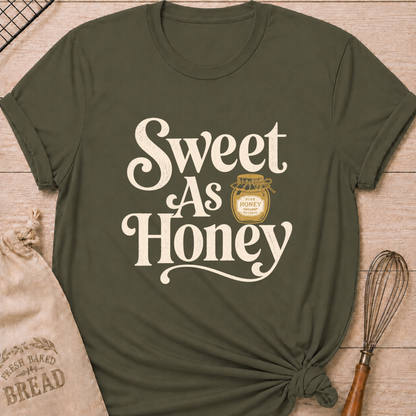 Military green women's relaxed fit t-shirt with the words Sweet as Honey in playful vintage lettering and a jar of golden honey.