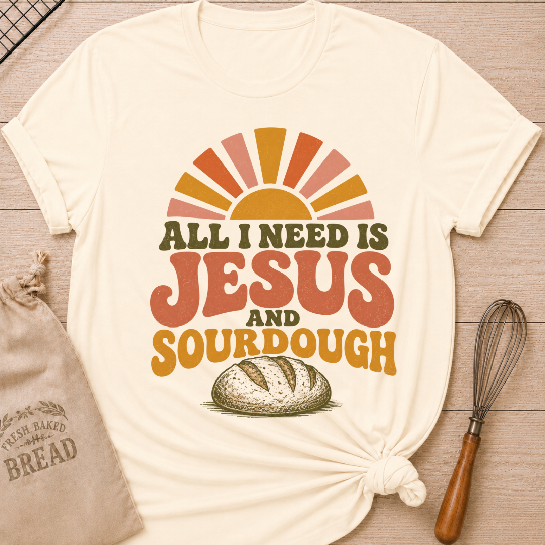 Natural All I Need Is Jesus and Sourdough women's relaxed fit tee with bold retro lettering, a rustic artisan loaf, and a sunrise