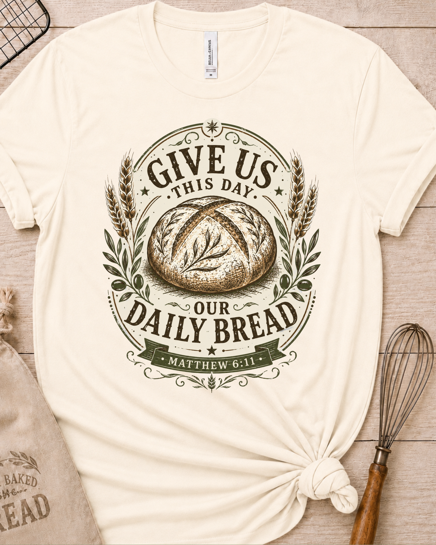 Natural cream women's relaxed fit t-shirt with the Daily Bread emblem printed in cream, a clean badge-style bread illustration inspired by Matthew 6:11.