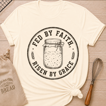Natural women's relaxed fit t-shirt with a vintage sourdough starter jar, wheat and the words Fed by Faith, Risen by Grace.