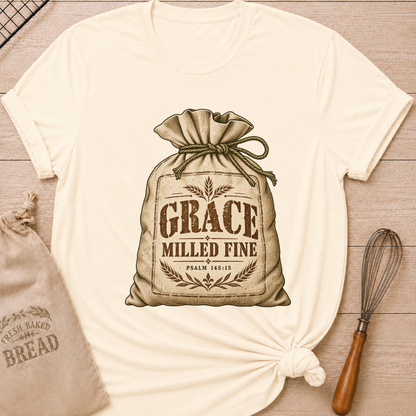 Natural women's relaxed fit tee with a vintage flour sack tied with rope, detailed with wheat motifs, Grace Milled Fine lettering and Psalm 145:15