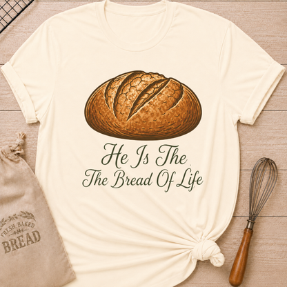 Natural women's relaxed fit t-shirt with the words He Is the Bread of Life in graceful vintage lettering and an illustrated artisan loaf.