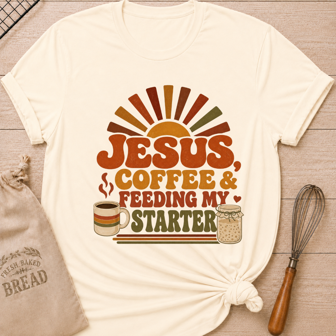 Natural women's relaxed fit t-shirt with the words Jesus, Coffee & Feeding My Starter in bold retro lettering with a steaming mug and a sourdough starter jar.