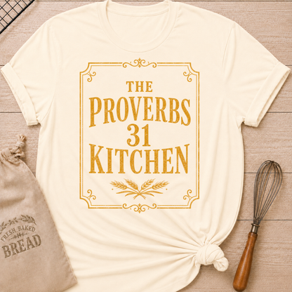 Natural women's relaxed fit t-shirt with the words The Proverbs 31 Kitchen in bold vintage lettering with wheat details in an old-fashioned bakery sign style.