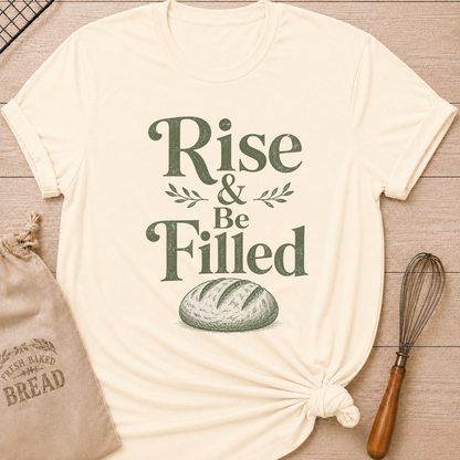 Natural women's relaxed fit t-shirt with the words Rise and Be Filled in vintage lettering above a rustic loaf of bread and leafy accents.