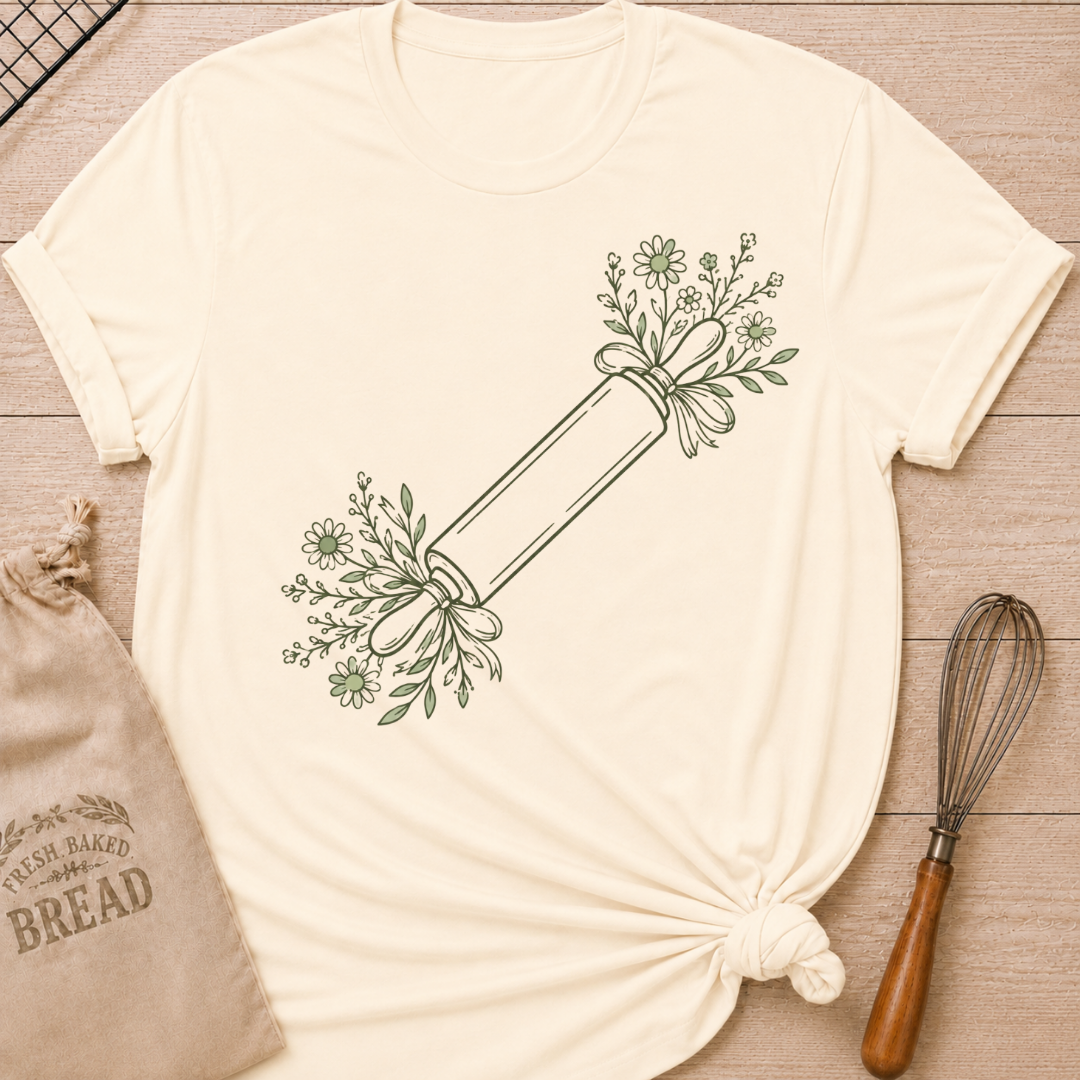 Natural women's relaxed fit t-shirt with a rolling pin dressed in soft floral sprigs and bows.