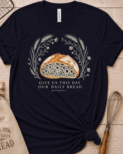 Navy women's relaxed fit t-shirt with the Daily Bread design featuring a rustic half loaf of bread, inspired by Matthew 6:11.