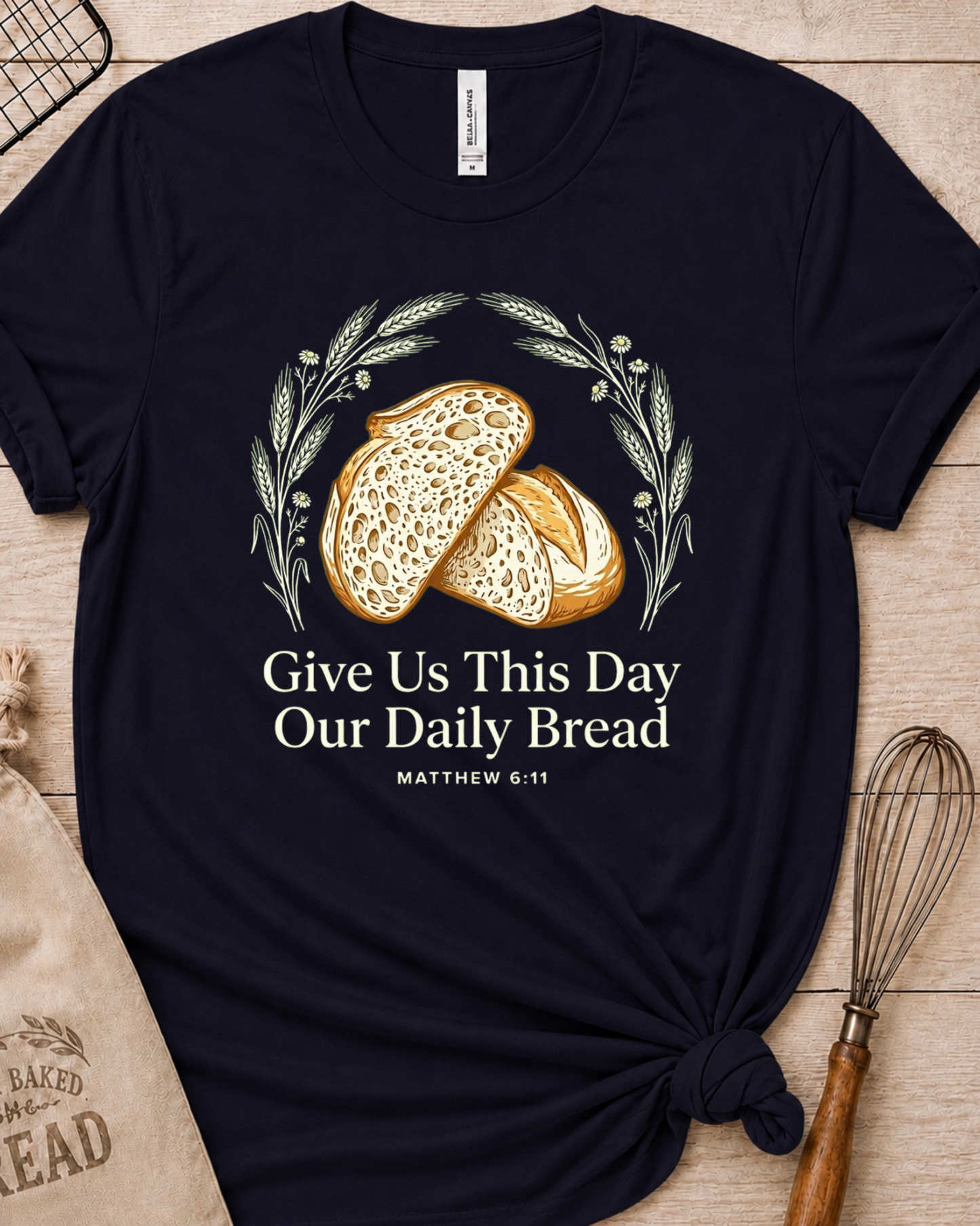 Navy women's relaxed fit t-shirt with the Daily Bread design featuring two rustic half loaves side by side, inspired by Matthew 6:11.