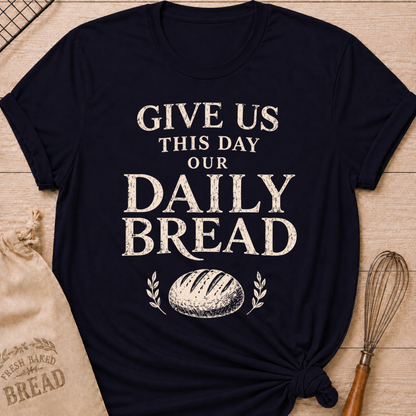 Navy women's relaxed fit t-shirt with the words Give Us This Day Our Daily Bread in bold vintage lettering above a rustic loaf and leafy accents.