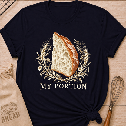 Navy women's relaxed fit tee with a detailed slice of artisan bread framed by wheat and delicate wildflowers in warm earthy tones, with My Portion lettering below