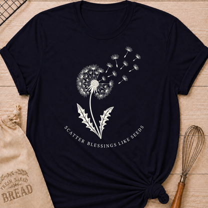 Navy women's relaxed fit t-shirt with a dandelion releasing its seeds and the words Scatter Blessings Like Seeds.
