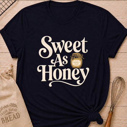 Navy women's relaxed fit t-shirt with the words Sweet as Honey in playful vintage lettering and a jar of golden honey.