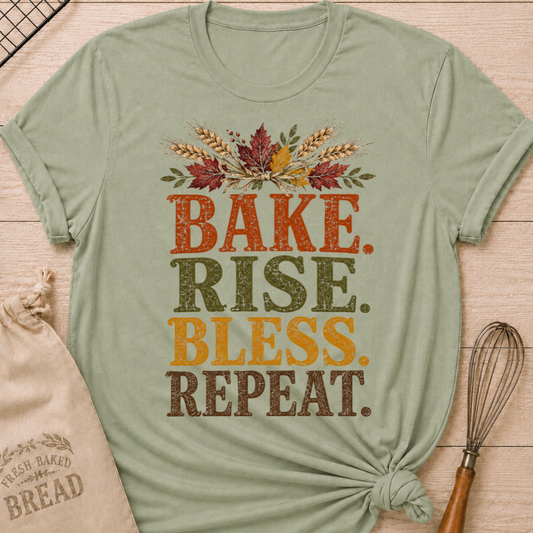 Sage women's relaxed fit tee with distressed vintage Bake Rise Bless Repeat lettering and a tied bundle of wheat and autumn leaves
