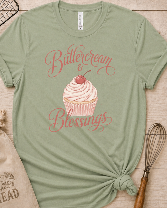 Sage green women's relaxed fit t-shirt reading Buttercream and Blessings with a frosted cupcake illustration.