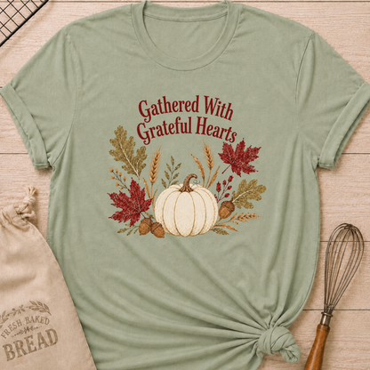 Sage women's relaxed fit tee with Gathered With Grateful Hearts lettering above a soft ivory pumpkin surrounded by wheat, acorns, berries and richly colored autumn leaves