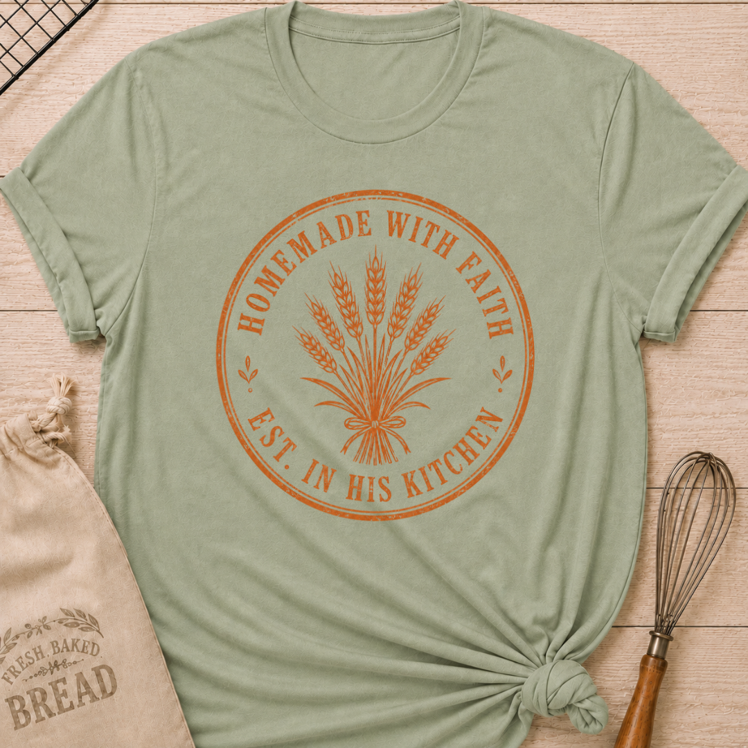 Sage green women's relaxed fit t-shirt with the words Homemade with Faith in a vintage market emblem around a tied bundle of wheat.