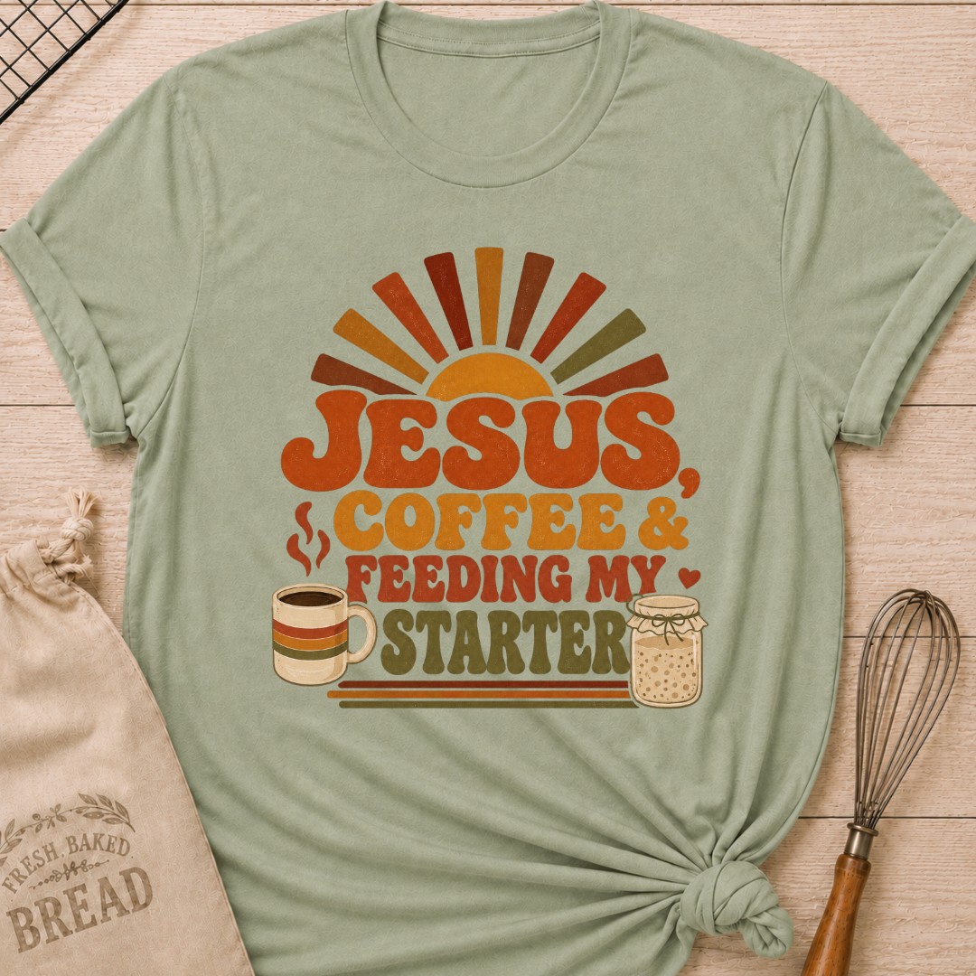 Sage green women's relaxed fit t-shirt with the words Jesus, Coffee & Feeding My Starter in bold retro lettering with a steaming mug and a sourdough starter jar.