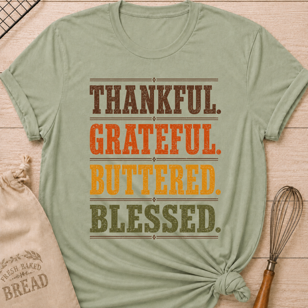 Sage women's relaxed fit tee with bold distressed Thankful Grateful Buttered Blessed lettering stacked in warm harvest brown, orange, gold and olive