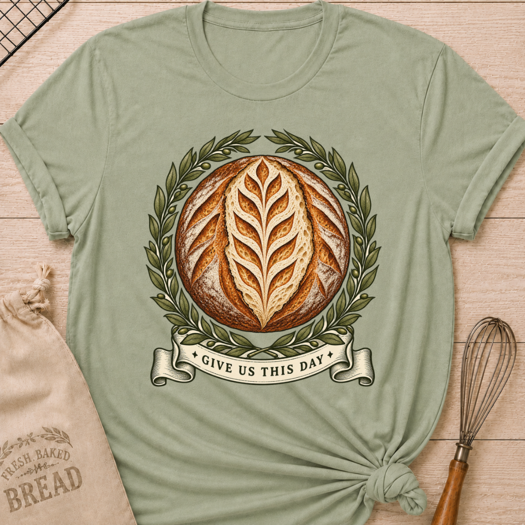 Sage women's relaxed fit tee with a scored artisan loaf framed by olive branches, finished with a vintage banner reading Give Us This Day