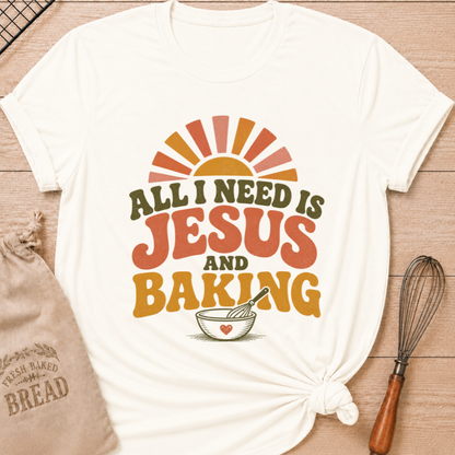 Vintage White All I Need Is Jesus and Baking women's relaxed fit tee with bold retro lettering, a rising sun, mixing bowl, and whisk
