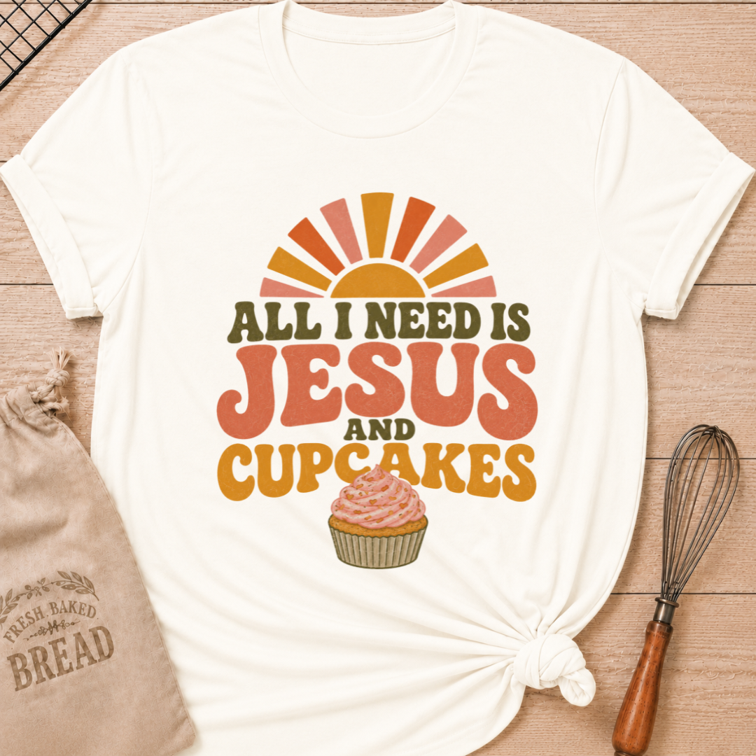 Vintage White All I Need Is Jesus and Cupcakes women's relaxed fit tee with retro lettering and a pink frosted cupcake in warm sunrise colors