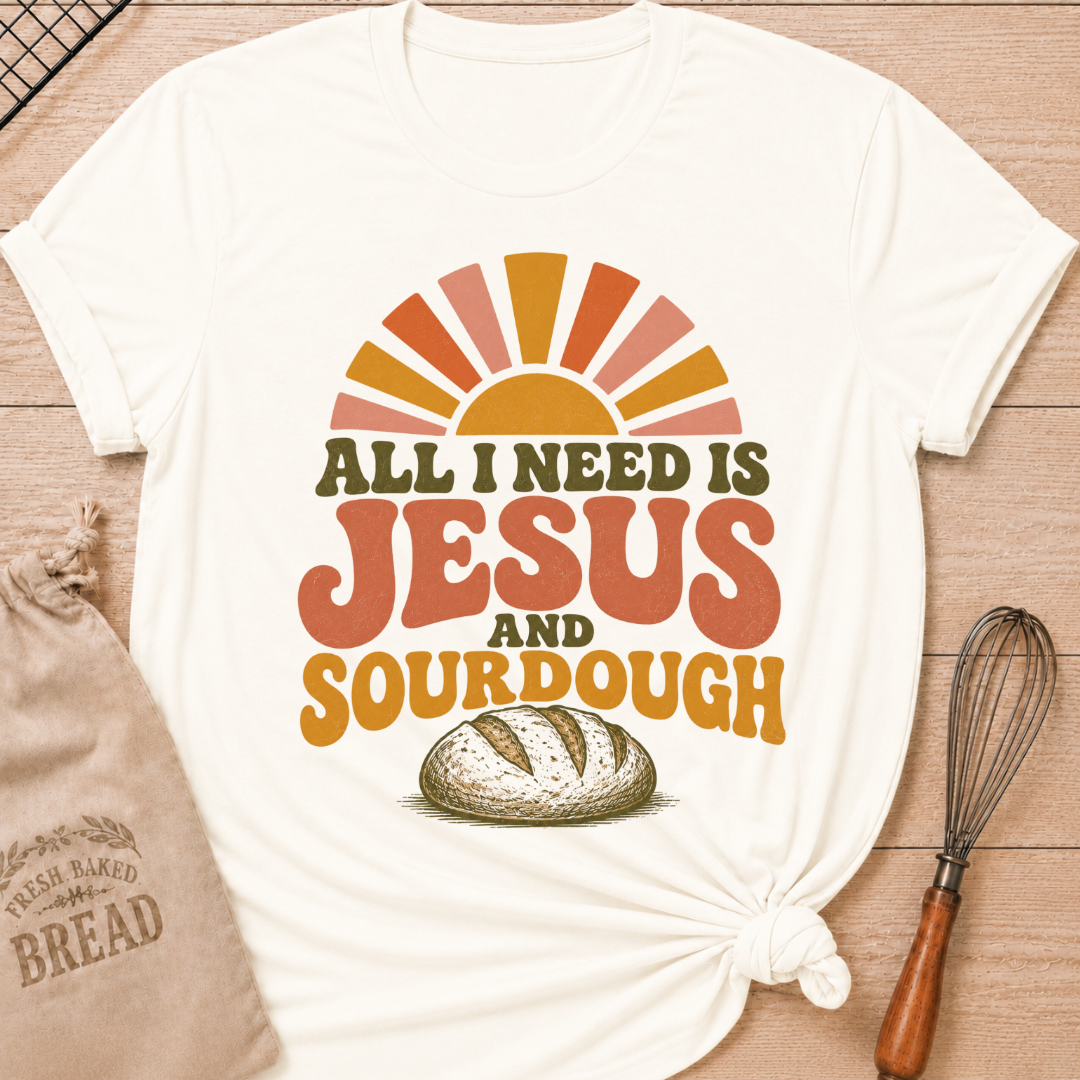 Vintage White All I Need Is Jesus and Sourdough women's relaxed fit tee with bold retro lettering, a rustic artisan loaf, and a sunrise