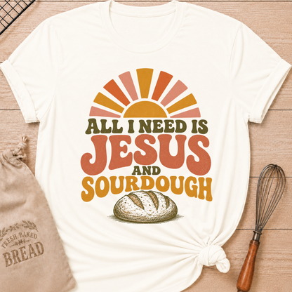 Vintage White All I Need Is Jesus and Sourdough women's relaxed fit tee with bold retro lettering, a rustic artisan loaf, and a sunrise