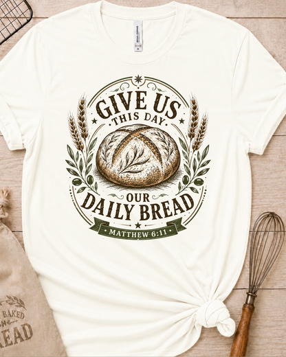 Vintage white women's relaxed fit t-shirt with the Daily Bread emblem, a clean badge-style bread illustration inspired by Matthew 6:11.