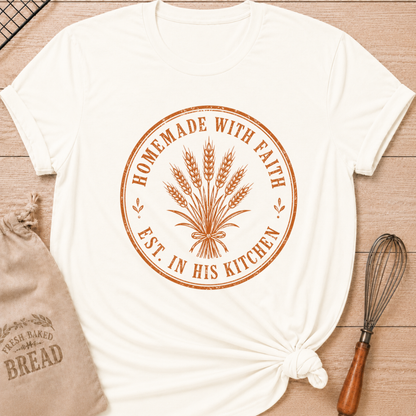 Vintage white women's relaxed fit t-shirt with the words Homemade with Faith in a vintage market emblem around a tied bundle of wheat.