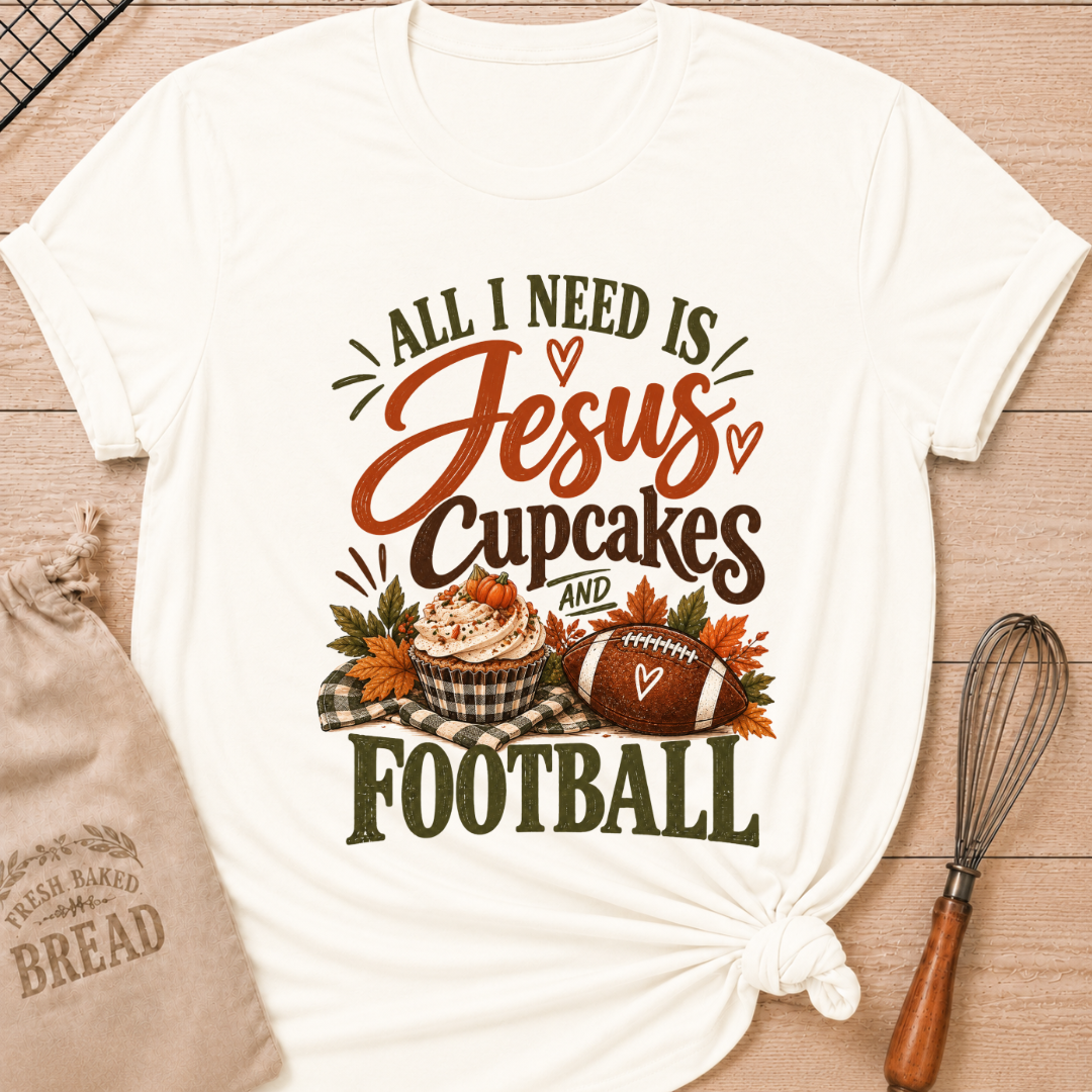 Vintage White women's relaxed fit tee with bold vintage All I Need Is Jesus, Cupcakes and Football lettering, a pumpkin topped cupcake, autumn leaves and a football on a gingham blanket