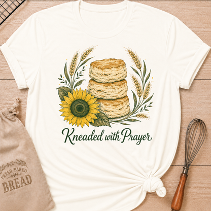 Vintage White Kneaded With Prayer women's relaxed fit tee with a stack of homemade biscuits, golden wheat, and a sunflower