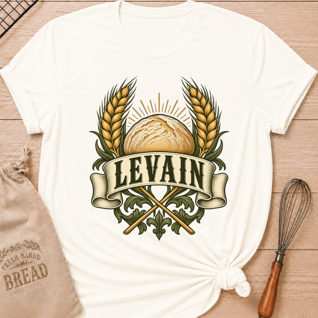 Vintage White women's relaxed fit tee with a rustic loaf between golden wheat and radiant accents, with Levain lettering on an old-world banner