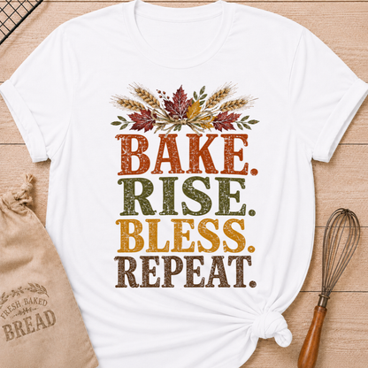 White women's relaxed fit tee with distressed vintage Bake Rise Bless Repeat lettering and a tied bundle of wheat and autumn leaves