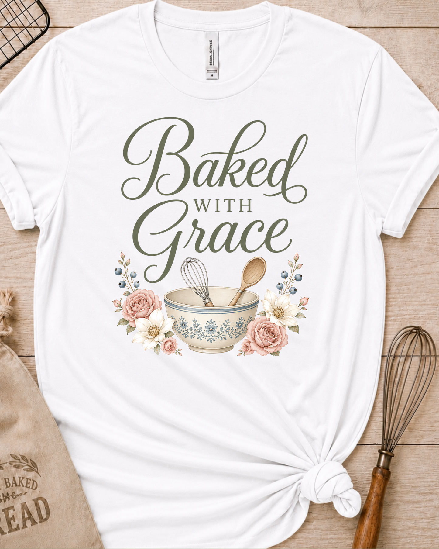 White women's relaxed fit t-shirt with Baked with Grace in script surrounded by soft blue watercolor florals.